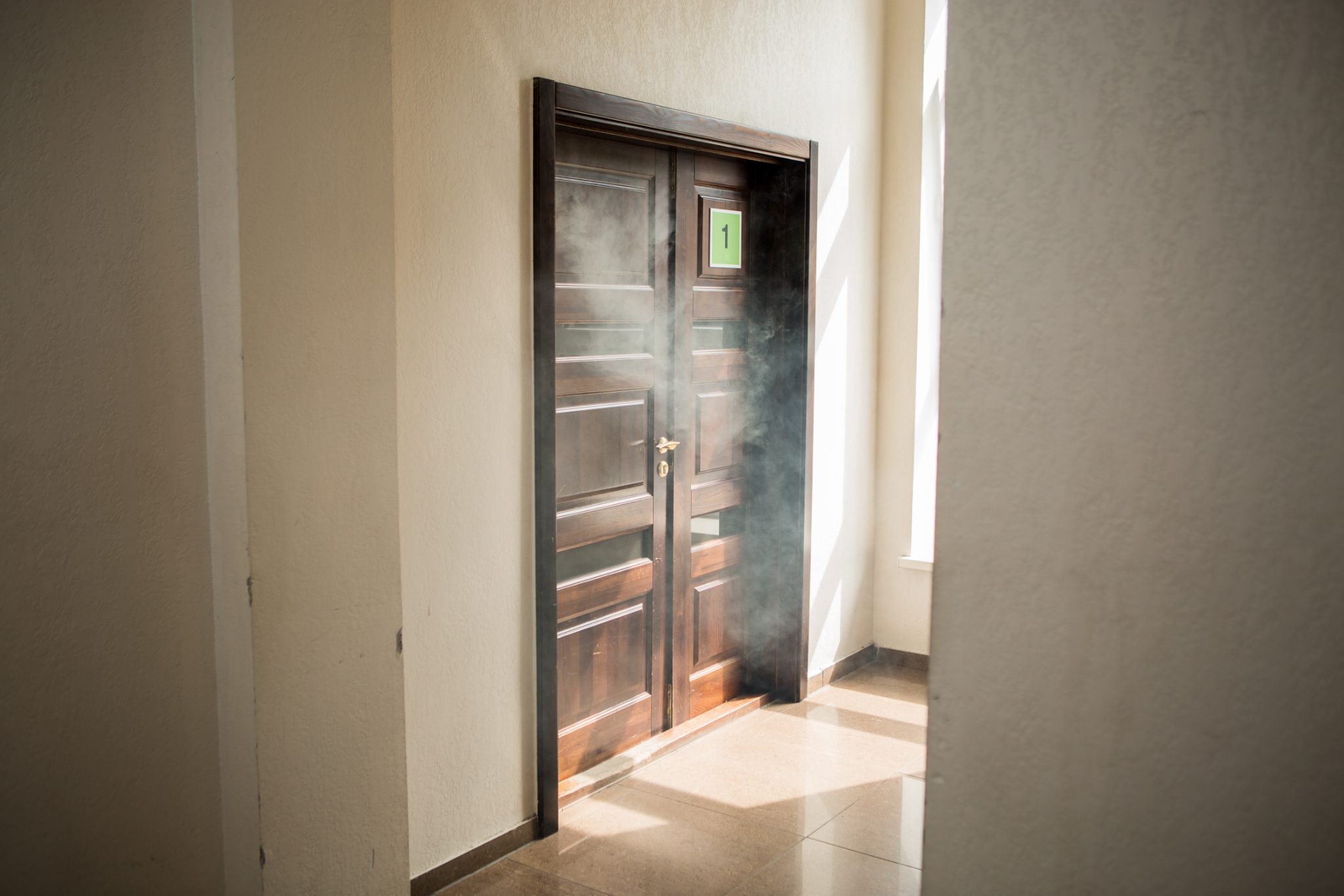 Smoke drifting through an interior doorway after a fire