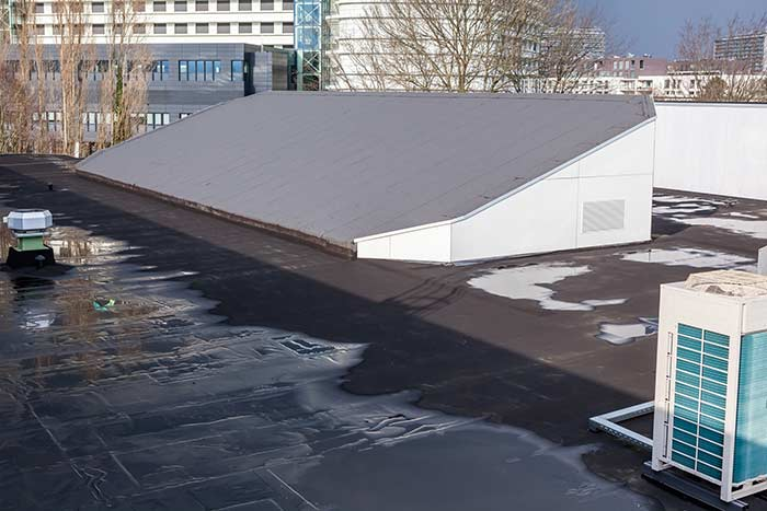 Commercial flat roof with pooled storm water