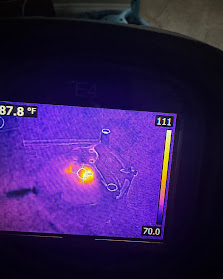 Thermal imaging camera revealing hidden moisture behind a wall